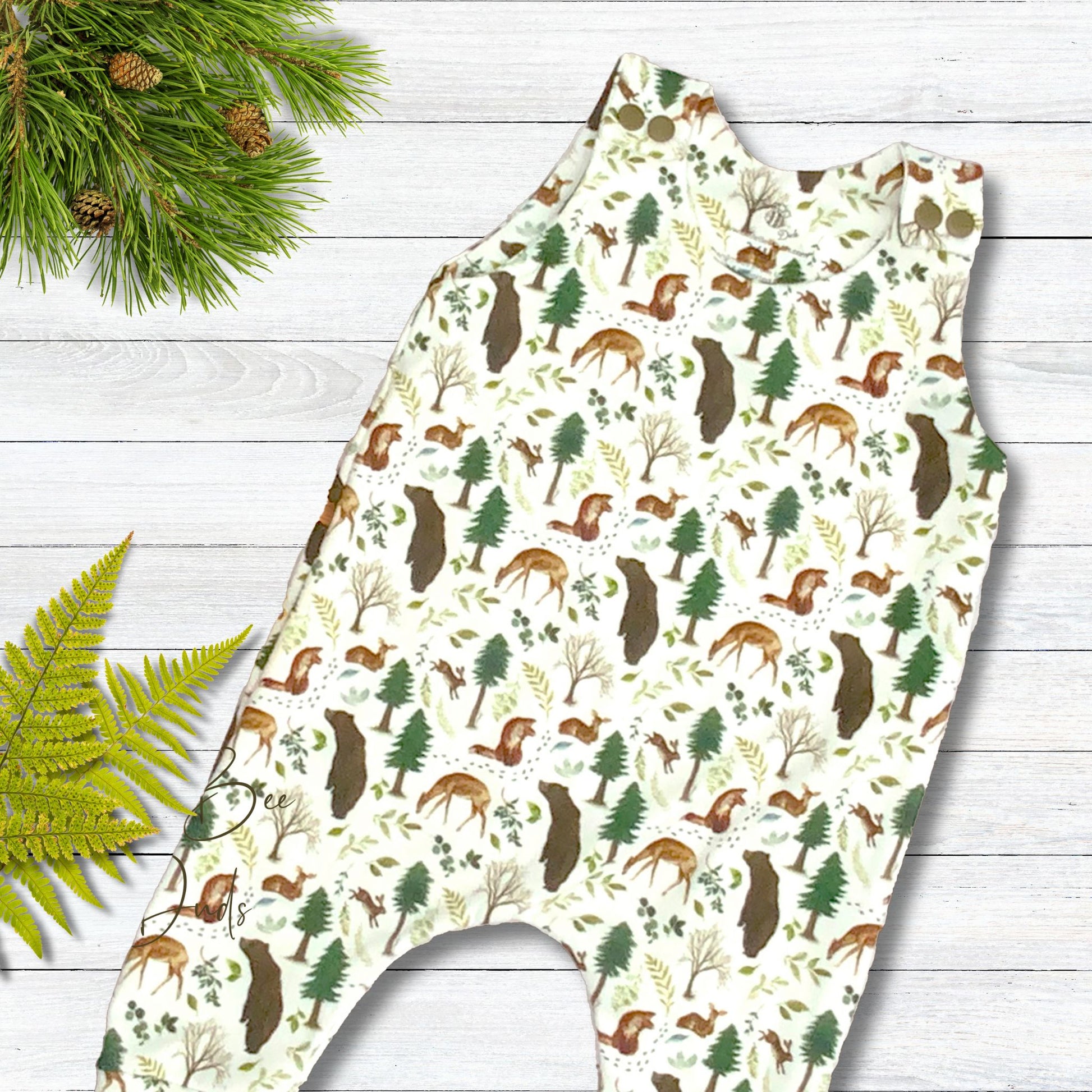 Fun forest wildlife print with deer, bears and more on a white background.  Long romper in organic cotton with matching shoulder snaps